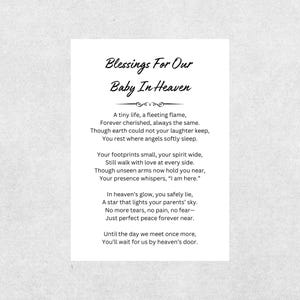 May include: A white card with the text "Blessings For Our Baby In Heaven" in elegant script. The card contains a poem about a baby in heaven, with lines like "A tiny life, a fleeting flame" and "Just perfect peace forever near."