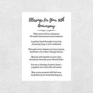May include: A white card with the text "Blessings for Your 50th Anniversary" in elegant script. The card contains a poem about love and blessings for a 50th anniversary. The text is in black.