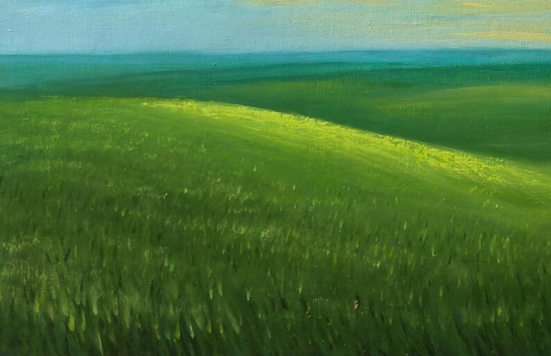 May include: An oil painting depicts a vibrant green field under a light blue sky. The grassy landscape features rolling hills, with sunlight illuminating the crests and casting shadows. The artwork evokes a sense of tranquility.