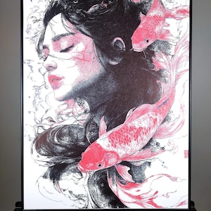 May include: A black and white pen and ink drawing of a woman with long black hair and closed eyes. Two red koi fish are swimming around her head and body. The drawing is on a white background.