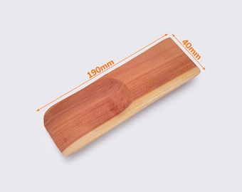 May include: A wooden shoe stretcher with a curved shape and a rounded indentation in the center. The stretcher is 190mm long and 40mm wide.