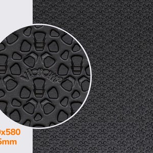 May include: Close-up of a black textured surface with a repeating pattern of small, raised hexagons. The surface is 910x580 and 4.5mm thick.