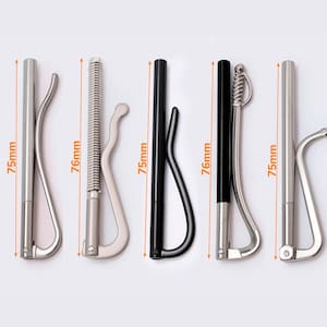 May include: Five money clips, each approximately 75mm long, displayed against a white background. The clips vary in design, including silver and black finishes, with some featuring spring mechanisms and curved handles.