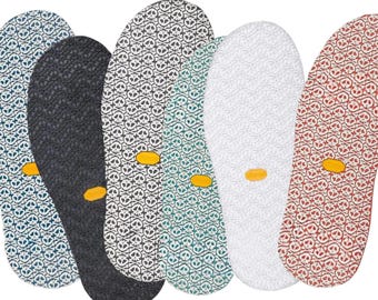 May include: Five different patterned shoe insoles with a yellow accent. The insoles are in various colors, including blue, black, white, and red.