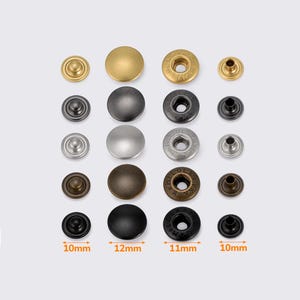 Puede incluir: Taza de cerámica blanca con asa negra y el texto "But First, Coffee" en negrita negra. La taza está sobre una superficie blanca. Adecuada para bebidas calientes.