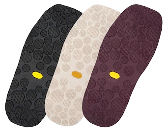 May include: Three shoe soles in black, beige, and burgundy with a textured pattern of small circles and a yellow accent in the center.