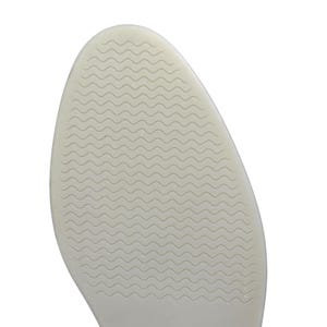 May include: Close-up of a shoe sole in a light beige hue. The sole has a rounded form and a textured surface featuring a wavy pattern. The design is consistent across the entire sole, offering grip and support.
