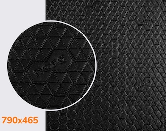 May include: Close-up of a black textured surface with a repeating pattern of triangles. The word "nora" is embossed in the center of the image.