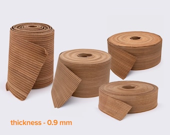 May include: Four rolls of brown corrugated paper ribbon, each with a thickness of 0.9 mm. The rolls vary in size, with some partially unrolled, revealing the ribbed texture. The text "thickness - 0.9 mm" is displayed in orange.