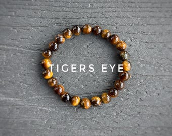 Bracciale elastico con cristalli Occhio di Tigre infusi con Reiki per fiducia e protezione
