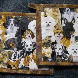 May include: Two brown and gold fabric pot holders with a colorful pattern of various dog breeds. The pot holders have a brown and gold border with a dotted pattern.