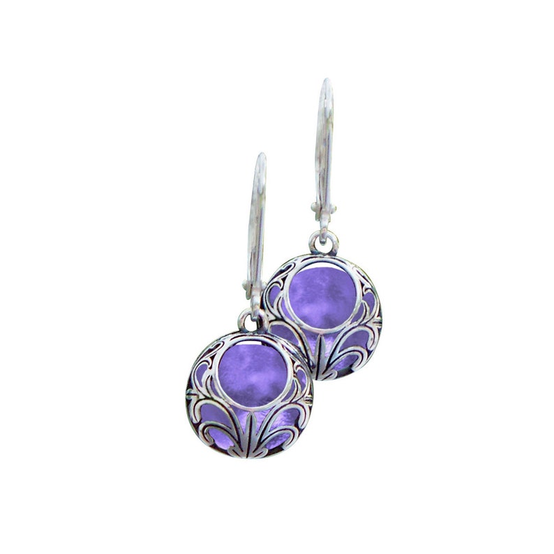 May include: A pair of silver earrings with a purple stone set in a filigree design.