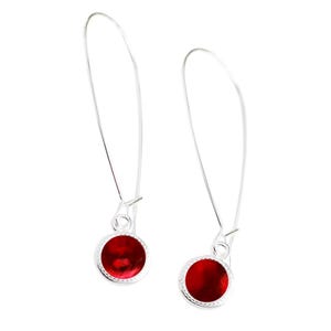May include: A pair of silver dangle earrings with red round cabochon stones.