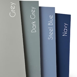 May include: Four color swatches of paint samples. The colors are grey, dark grey, steel blue, and navy.