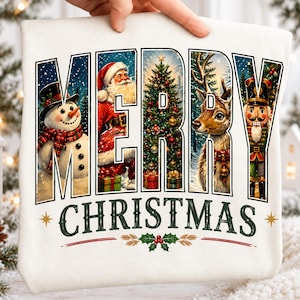 May include: A white t-shirt featuring the text MERRY CHRISTMAS in large block letters. Each letter contains a festive scene including a snowman, Santa Claus, a decorated Christmas tree, a reindeer, and a nutcracker. The design includes holly accents.