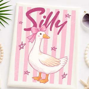 May include: A whimsical illustration of a white goose with a pink bow, set against a backdrop of pink and white stripes. The word "Silly" is written in pink script above the goose, with pink stars scattered around the design. The artwork has a playful, cartoonish style.
