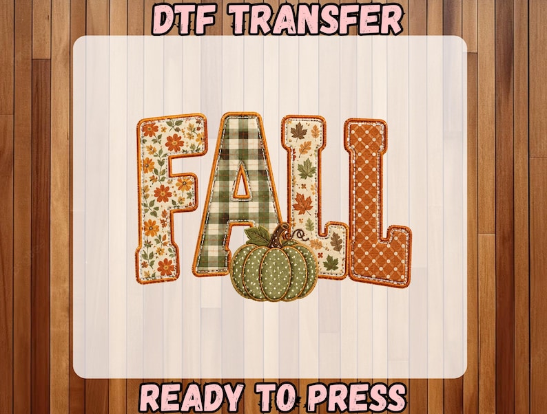 May include: A DTF transfer sheet featuring the word FALL in block letters with varied patterns including orange flowers, green plaid, autumn leaves, and orange polka dots, accompanied by a green polka dot pumpkin graphic and text READY TO PRESS.