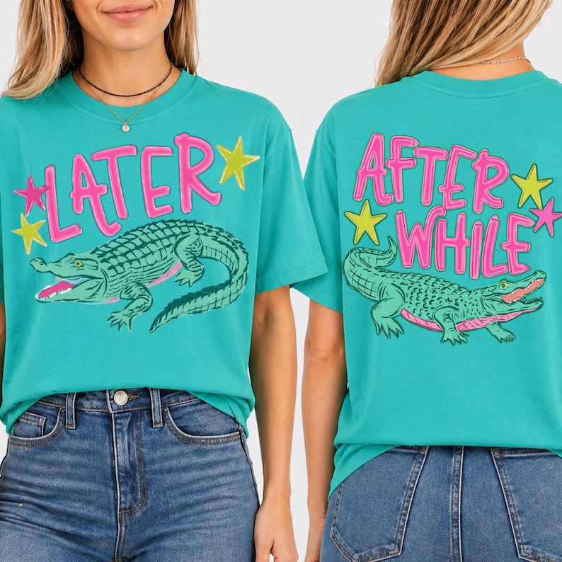 May include: Teal t-shirts with a front and back design. The front of the shirt says "LATER" in pink with a green alligator graphic. The back says "AFTER WHILE" in pink with a green alligator graphic. The text and alligator are outlined in pink and green.