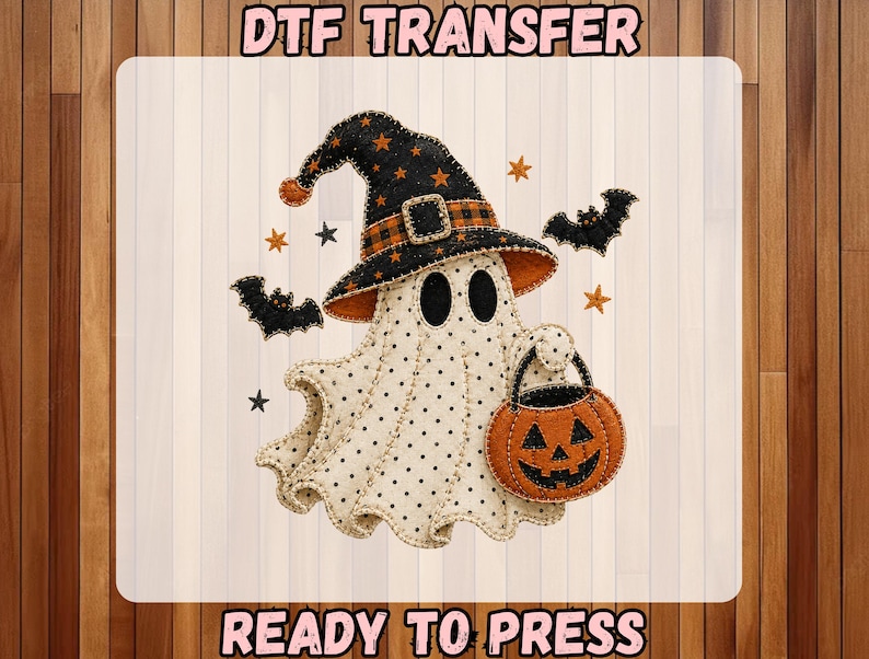 May include: A DTF transfer featuring a cream-colored ghost with black polka dots, wearing a black witch hat with orange stars and a plaid band. The ghost holds an orange jack-o'-lantern bucket, surrounded by black bats and small stars.