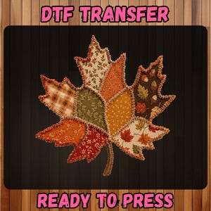 May include: A DTF transfer featuring a large maple leaf graphic composed of various fabric-like patches in autumn colors including orange, brown, green, and cream. The text DTF TRANSFER and READY TO PRESS appears in pink letters above and below the leaf.