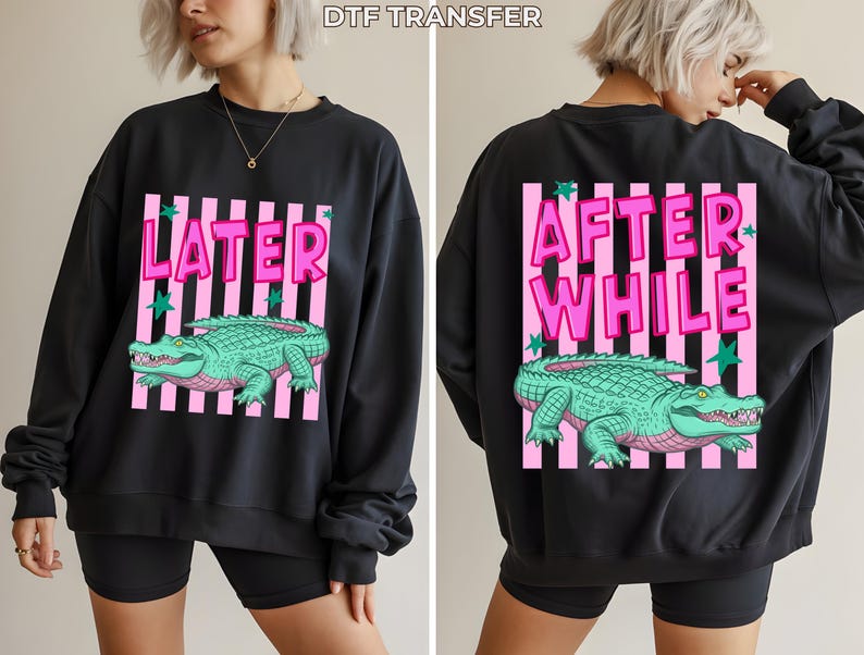 May include: Black sweatshirt with a pink and white striped design. The front features the word "LATER" above a green alligator illustration. The back of the sweatshirt has the words "AFTER WHILE" above the same alligator design.