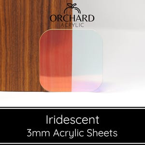 May include: Iridescent 3mm acrylic sheets. The sheets are clear with a rainbow iridescent sheen. The sheets are shown against a wood background.
