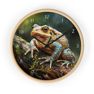 May include: A clock with a green, brown, and yellow frog on a mossy log. The clock face has white numbers and black hands.