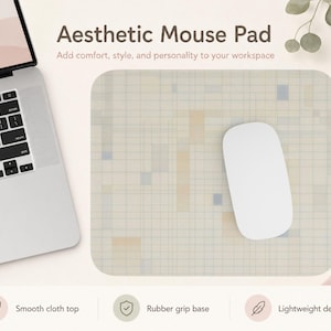 May include: A rectangular mouse pad featuring a grid pattern with soft beige, tan, and light blue rectangular accents. The mouse pad has a smooth cloth top and a rubber grip base. A white computer mouse rests on the surface of the pad.