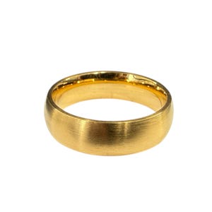 May include: A gold-coloured ring with a brushed, matte exterior finish and a smooth, polished interior surface. The band features a rounded, domed profile that creates a consistent circular shape, showcasing a metallic texture throughout the outer surface.
