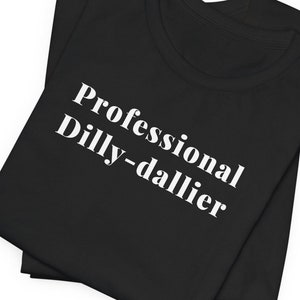 May include: Black t-shirt with white text that reads "Professional Dilly-dallier".
