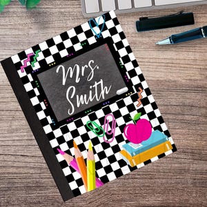 May include: A notebook with a black and white checkered pattern. The notebook features a chalkboard design with the name "Mrs. Smith" in white script. Colorful pencils, paperclips, and an apple graphic are also visible.