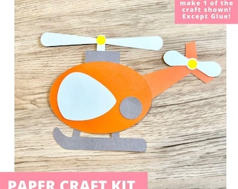 May include: A paper craft kit featuring a helicopter cutout with an orange body, light blue window, gray landing skids, and light blue rotor blades with yellow centers. The text reads: Includes everything needed to make 1 of the craft shown! Except Glue!