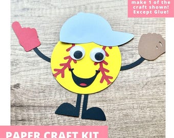 May include: A paper craft kit featuring a yellow softball character with red stitching, a light blue baseball cap, googly eyes, a black mouth, black arms and legs, a red foam finger, and a brown baseball glove. Text reads: Includes everything needed to make 1 of the craft shown! Except Glue! PAPER CRAFT KIT PRE-CUT CRAFTS FOR KIDS