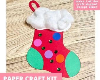 May include: A red paper Christmas stocking craft with a white cotton ball cuff, green paper toe and heel, and colorful paper circles and green sequins. The text reads: Includes everything needed to make 1 of the craft shown! Except Glue!
