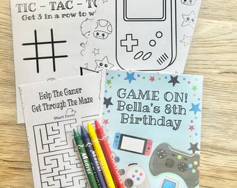 May include: A set of activity sheets featuring a tic-tac-toe game, a handheld gaming console coloring page, a maze with the text Help The Gamer Get Through The Maze, and a birthday card with the text GAME ON! Bella's 8th Birthday, plus three crayons.
