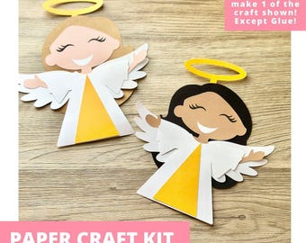 May include: Two paper angel crafts featuring smiling faces, white wings, yellow dresses, and yellow halos. One angel has light brown hair, the other has black hair. Text reads: Includes everything needed to make 1 of the craft shown! Except Glue!