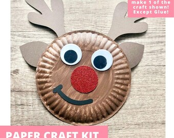 May include: A paper plate reindeer craft kit featuring a brown painted paper plate, two brown paper antlers, two googly eyes, a red glittery nose, and a black paper smile. Text on image: Includes everything needed to make 1 of the craft shown! Except Glue! PAPER CRAFT KIT PRE-CUT CRAFTS FOR KIDS