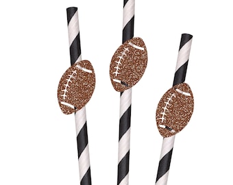 May include: Three paper drinking straws featuring a black and white diagonal striped pattern. Each straw is decorated with a brown glittery football cutout attached to the center, showcasing white stitched details on the surface of the ball.