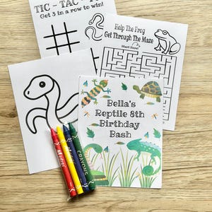 May include: A set of activity sheets including a Tic-Tac-Toe game, a frog maze, a snake coloring page, and a personalized card titled Bella's Reptile 8th Birthday Bash with reptile illustrations, accompanied by a small pack of four colored crayons.