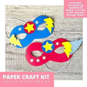 May include: Two superhero masks, one blue and one red, with yellow lightning bolts and stars. The masks are part of a paper craft kit for kids. The kit includes everything needed to make one mask, except glue.