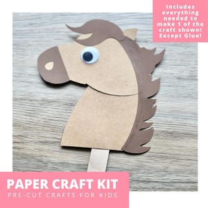 May include: A paper craft kit featuring a horse head cutout made of tan and dark brown cardstock with a single googly eye and a wooden craft stick handle. The text on the image reads: Includes everything needed to make 1 of the craft shown! Except Glue! PAPER CRAFT KIT PRE-CUT CRAFTS FOR KIDS.