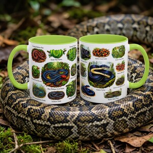 May include: Two white ceramic mugs with bright lime green handles and interiors, each featuring a detailed collection of various snake species illustrations with their common names printed in black text beneath each individual snake image.