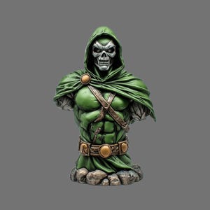May include: A green bust of a character with a skull-like face, wearing a hooded cloak and armor. The bust has a belt with gold-colored accents and is mounted on a rocky base. The figure's chest and shoulders are muscular.