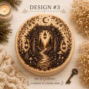 May include: A round wooden box featuring a laser-engraved forest scene with a stone path, hanging lanterns, mushrooms, and a crescent moon. The text DESIGN #3, Part of a Collection, and 5 DESIGNS TO CHOOSE FROM are printed on the surface.