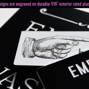 May include: Black and white sign with the text "EMPLO" and a pointing hand graphic. The sign is made of durable 1/16 inch exterior rated plastic.