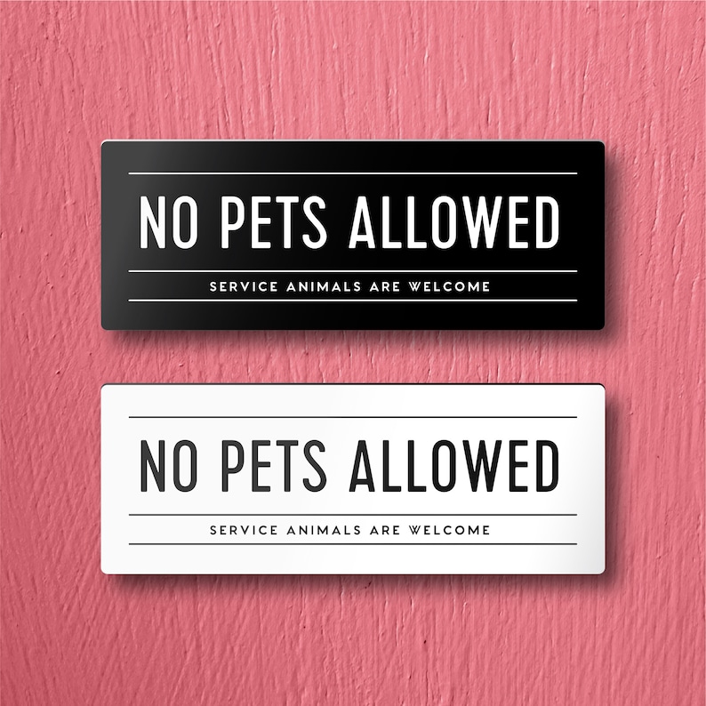 May include: Two signs, one black and one white, with the text "NO PETS ALLOWED" and "SERVICE ANIMALS ARE WELCOME" in black lettering.
