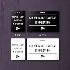 SURVEILLANCE CAMERAS In OPERATION Sign - Lightweight and easy to install, modern designs, made to order. With camera icon.