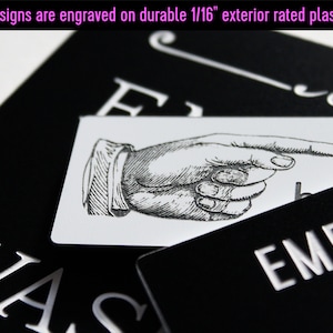 May include: Black and white sign with the text "EMPLO" and a pointing hand graphic. The sign is made of durable 1/16 inch exterior rated plastic.