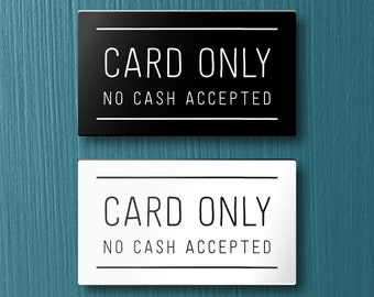 May include: Two signs, one black and one white, with the text "CARD ONLY NO CASH ACCEPTED" in white lettering.