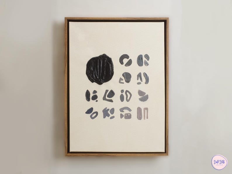 May include: A framed abstract painting with a black circle and various shapes in shades of blue and gray on a white background.